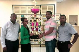  Banks DIH’s Denisa Paton hands over a trophy to Nasrudeen Mohamed Jr, signaling the company’s intention to be a main sponsor of the Triple Crown Series. 