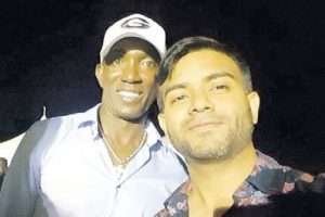Former T&T and Manchester United football Dwight Yorke poses for a photo with reigning Soca Chutney Monarch Neval Chatelal during the Island Vibe fete last march.