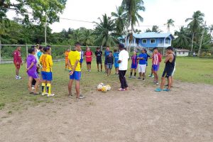 GFF Technical Development Officer Lyndon France makes a point to players from the Santa Rose area during a training session staged at the Kumaka Sports ground, as part of the GFF Two-Day Training Course on February 17 and 18. (Photo courtesy of the GFF)