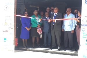 From left: Minister within the Ministry of Public Health, Dr. Karen Cummings; Minister within the Ministry of Natural Resources, Simona Broomes and Minister of Foreign Affairs, Carl Greenidge watch on as Minister of Natural Resources Raphael Trotman cuts the ribbon to officially open the Guyana International Petroleum Business Summit and Exhibition yesterday at the Marriott Hotel. 