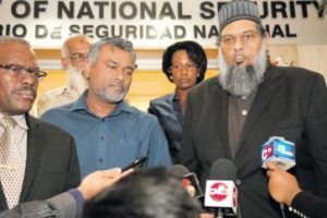 Imam Shiraz Ali, right, of the Nur-E-Islam Masjid, El Socorro Road, San Juan, addresses members of the media as Minister of National Security Edmund Dillon looks on, following a meeting at the Ministry of National Security on Abercromby Street, Port-of-Spain, yesterday.