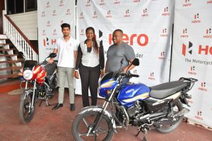 Petra Organization Co-Director Troy Mendonca (right) posing with the two motorcycles, alongside Representative of Rose Ramdehol Auto Joshua Ramdehol and Petra Organization member Jacklyn Boodie.