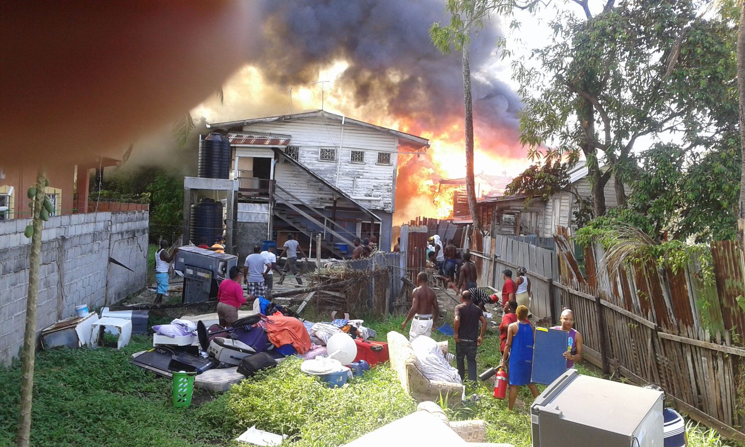 Residents helping to remove items from the burning houses.