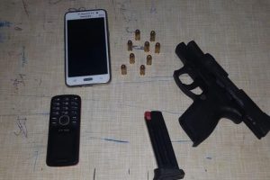 The gun and ammunition along with the cellular phones that were found on the North Ruimveldt resident. (Photo courtesy of Guyana Police Force)