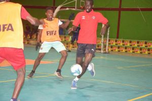 Reon Thomas (right) of Ansa McAl Stars trying to maintain possession against two Channel-9 players during their group match at the National Gymnasium in the Magnum Futsal Championship
