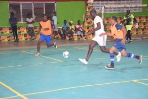 Sherwin Fordyce (centre) of Albouystown-B tries to maintain possession of the ball while being challenged by two Broad Street players during their group clash in the Magnum Mash Futsal Classic at the National Gymnasium, Mandela Avenue, Tuesday night.