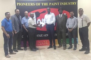 Torginol Paints Production Manager, Fenton Persaud hands over the sponsorship cheque to Lusignan Golf Club president Aleem Hussain in the presence of Company Secretary, Mohamed S. Ally, Marketing and Sales Manager, Rudy Jairam, PRO of the LGC, Guy Griffith and other representatives of Torginol Paints.
