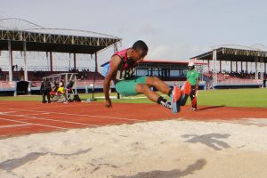 Anthony Williams soars in the long jump. (Orlando Charles photo)