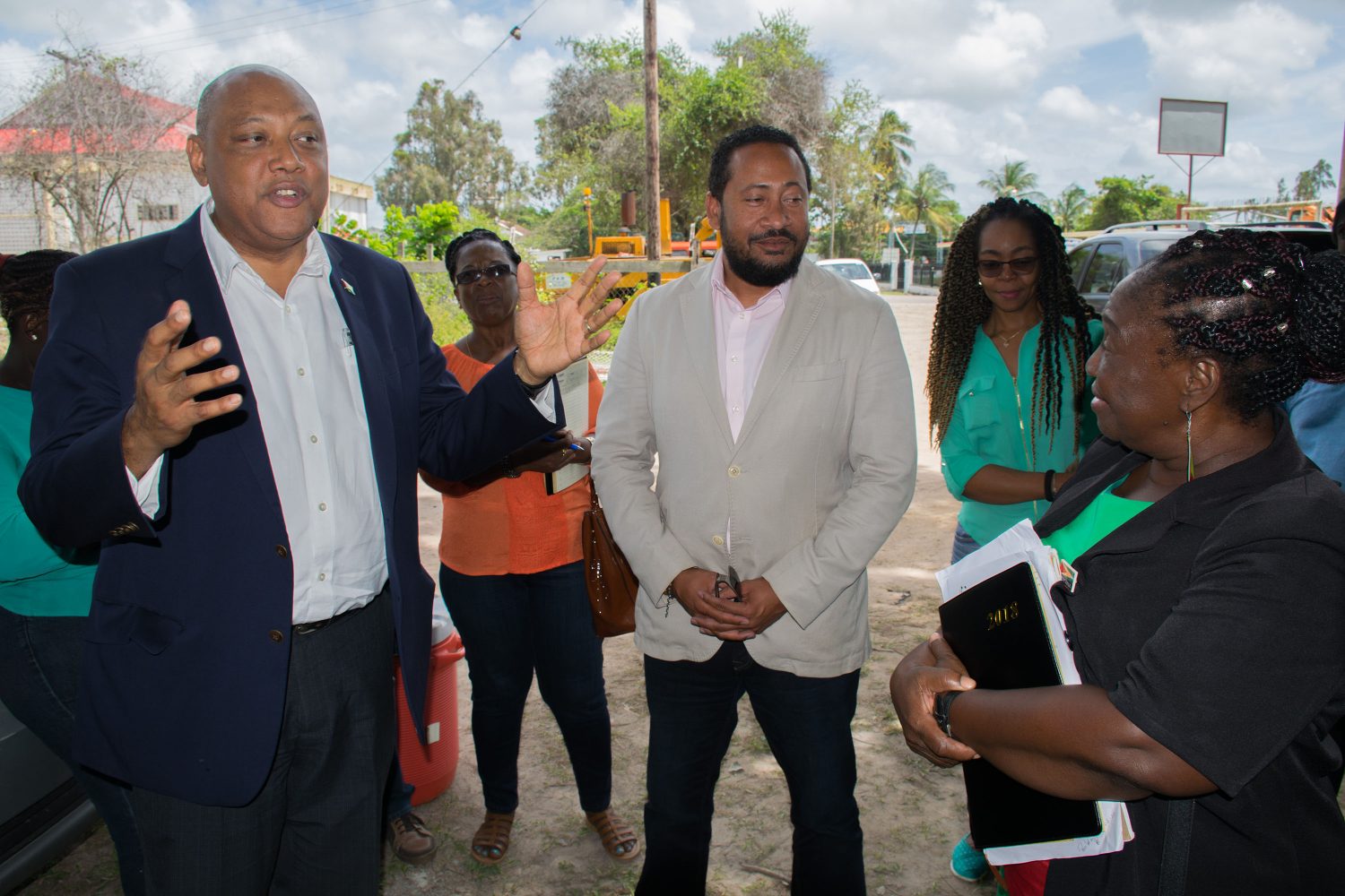 Minister of Natural Resources Raphael Trotman (left)    and New Amsterdam Mayor Winifred Haywood (right) with others during the visit.  (DPI photo)