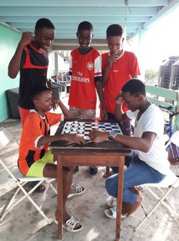 Boys engrossed in a
game of draughts