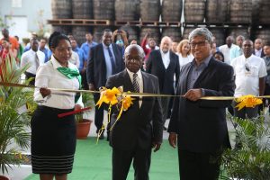 Minister of Foreign Affairs Carl Greenidge (left) and Chairman of Demerara Distillers Limited (DDL) Komal Samaroo (right) as they cut the ribbon yesterday to commission DDL’s new rum ageing warehouse. (Photo by Keno George)