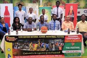 Members of the launch party for the National School Basketball Festival (NSBF) pose for a photo opportunity, following the conclusion of the ceremony. Sitting  are  Chico and Champion Brand Manager Reena Williams, left, Banks DIH Limited Communications Manager Troy Peters (third from left),  YBG Co-Director Chris Bowman (4th from left), Director of Sports Christopher Jones (3rd from right) and Ministry of Education’s Unit of Allied Arts representative Nicholas Fraser (2nd from right) 
