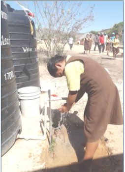 A student of Yurong Paru Primary School accessing treated water (GWI photo)