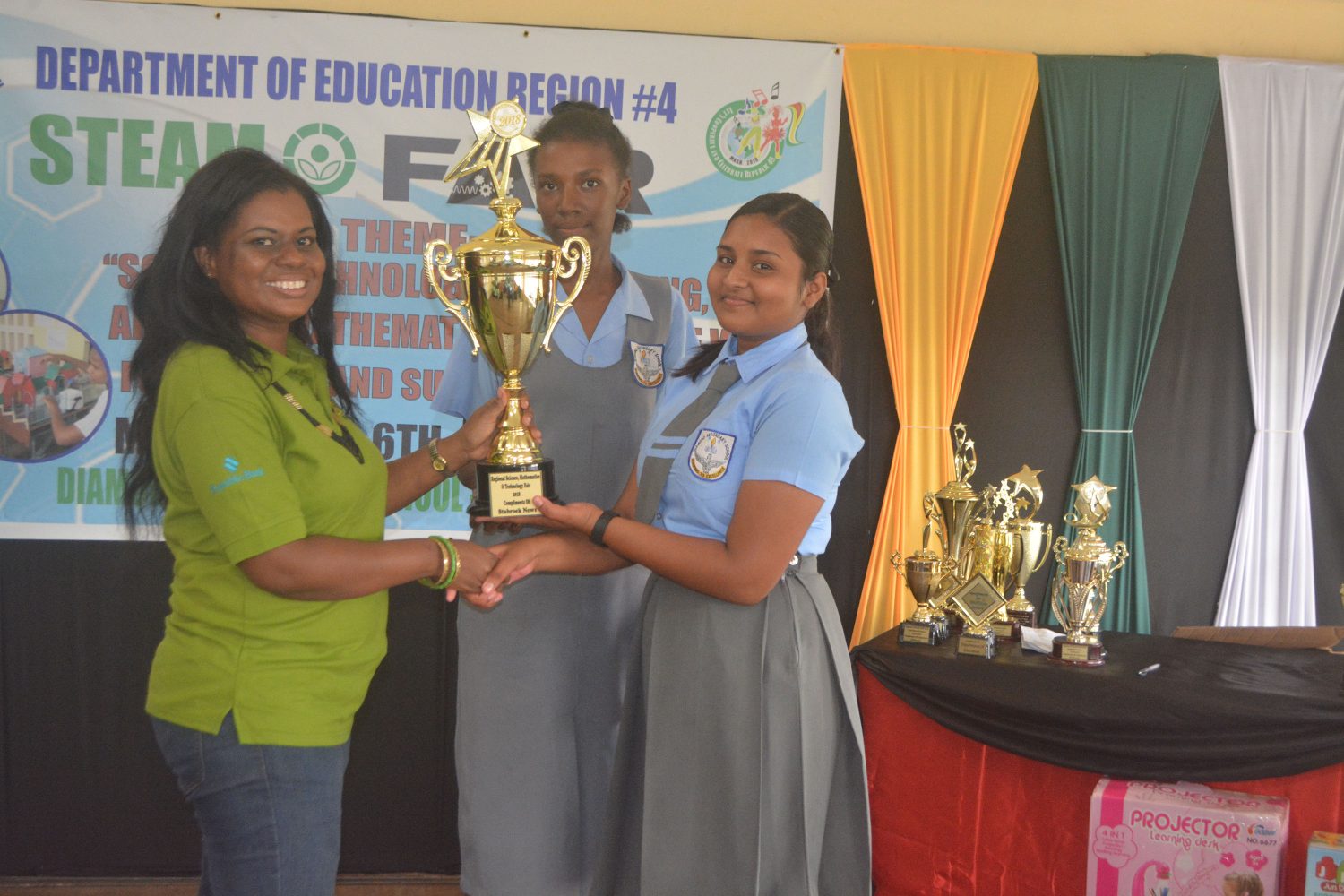 Students of Diamond Secondary receive a trophy donated by Stabroek News after winning one of the categories in the Region Four Science, Technology, Engineering, Arts and Mathematics (STEAM) Fair (Region Four Public Relations Department photo)