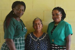 Invigilator Sarifari Persaud is flanked by Regional Education Officer Tiffany Favourite-Harvey and Education Officer attached to Region Four Stembiso Grant during a recent recognition of Persaud’s long service.