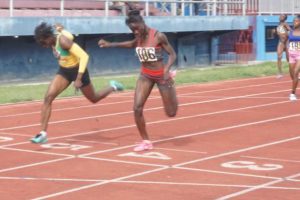 Sprint sensations, Kenisha Phillips (lane 5) and Deshanna Skeete (lane 4) race to the line yesterday in the 200m. While Skeete met the qualifying standard for the U-17 Girls 200 and 400m events, Phillips narrowly missed the mark in the U-20 Girls 100 and 200m races. Phillips posted 11.86s in the 100m which had a qualifying standard of 11.85s. Her 24.22s also narrowly missed the 200m qualifying time of 24.20s.