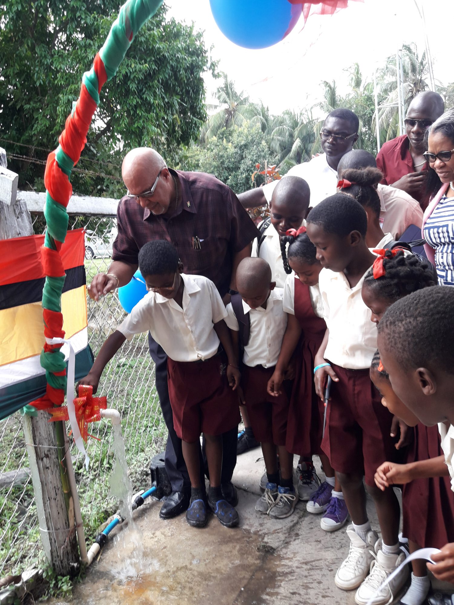 A Light Town Primary School Student turned on one of the newly installed stand pipes in the community on Thursday
