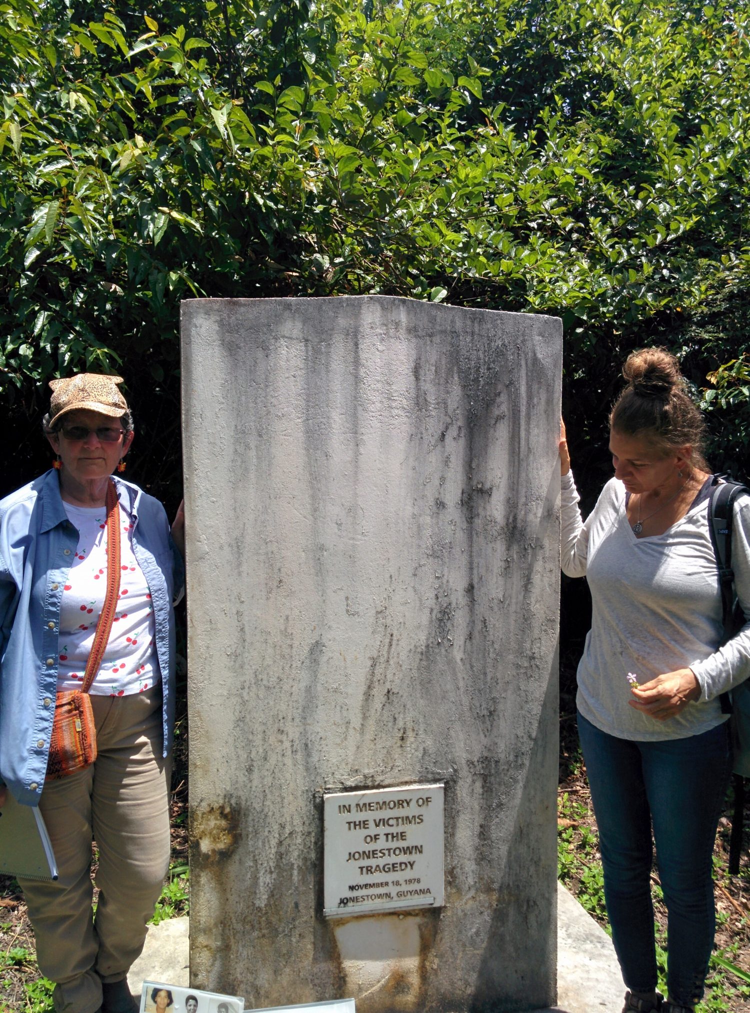 Laura Johnston Kohl (left)  and Jordan Vilchez at the tombstone in Jonestown that was built in honour of the victims