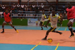 Alexander Village’s Leon Yaw (left) tussling with Joshua Browne (right) of Gold is Money for possession of the ball, during their round of 16 clash in the Petra Organization Futsal Championship at the National Gymnasium.