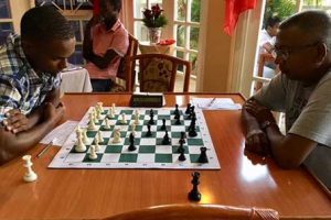  Loris Nathoo, right and Anthony Drayton during their third round clash of the Guyana Chess Federation senior Closed national Chess Championships last weekend at the Windjammer Hotel in Kitty.
