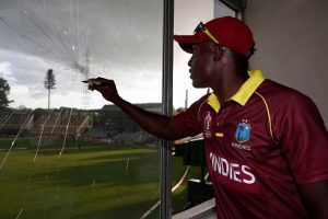 SIGN ON THE BROKEN GLASS! Rovman Powell signs a shattered window pane in the media centre which was as a result of one of his seven sixes. (Photo courtesy CWI Media) 