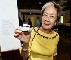 Gloria Palomino shows off the first to legal purchase of medical Cannabis in Jamaica.