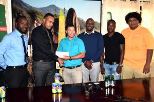 Top Brands Marketing Manager, Marvin Wray (second from left) handing over the sponsor’s pact to GRFU Treasurer Ryan Gonsalves yesterday. Also pictured are (from left) Esan Griffith (PRO), Vice President Rawle Toney, Pepsi Hornets player Blaise Bailey and Teron McCalmon. 