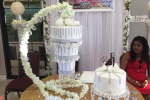  One of the cake decorators showcasing her elaborate design at the Wedding Expo last evening. 