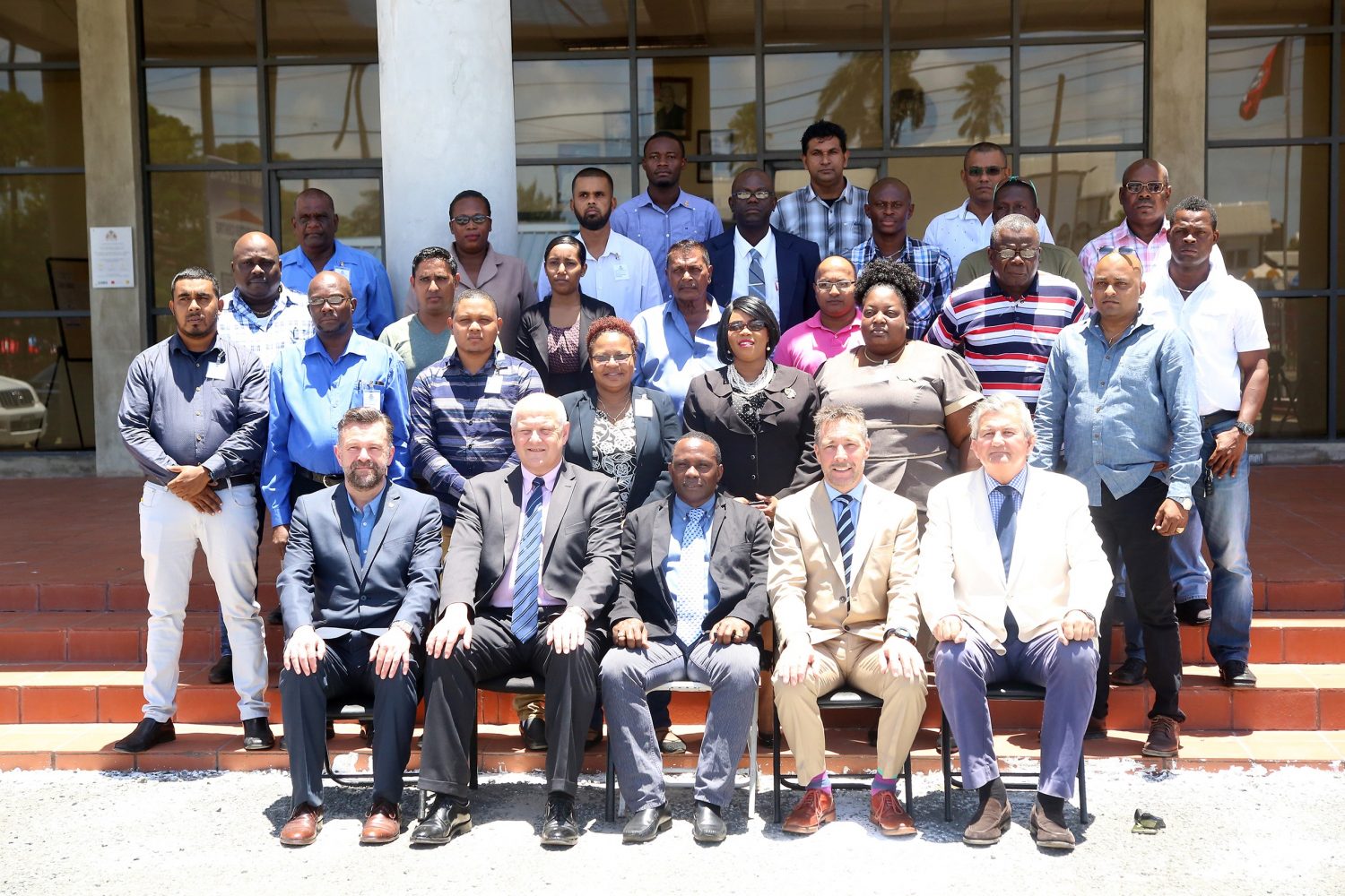 The participants pose for a group picture with (sitting from right to left) Security Reform Advisor to the President Russell Combe, Irish security expert Sam Sittlington, Crime Chief, Paul Williams and the UK-based facilitators Tony Crampton and Mark Dilliway.