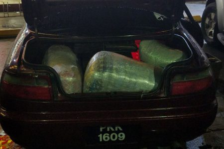 The abandoned car, PKK 1609, with some of the marijuana packed in the trunk.
