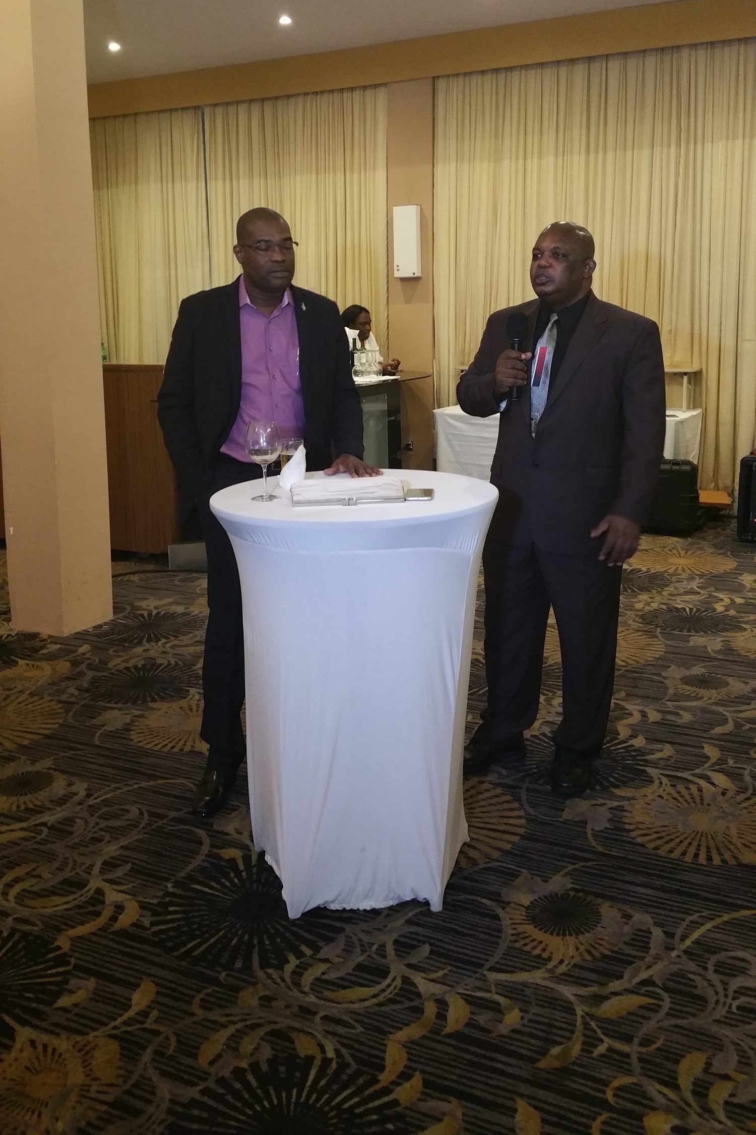 Albert Gordon (right) addressing attendees last evening with Minister of Public Infrastructure David Patterson by his side. 