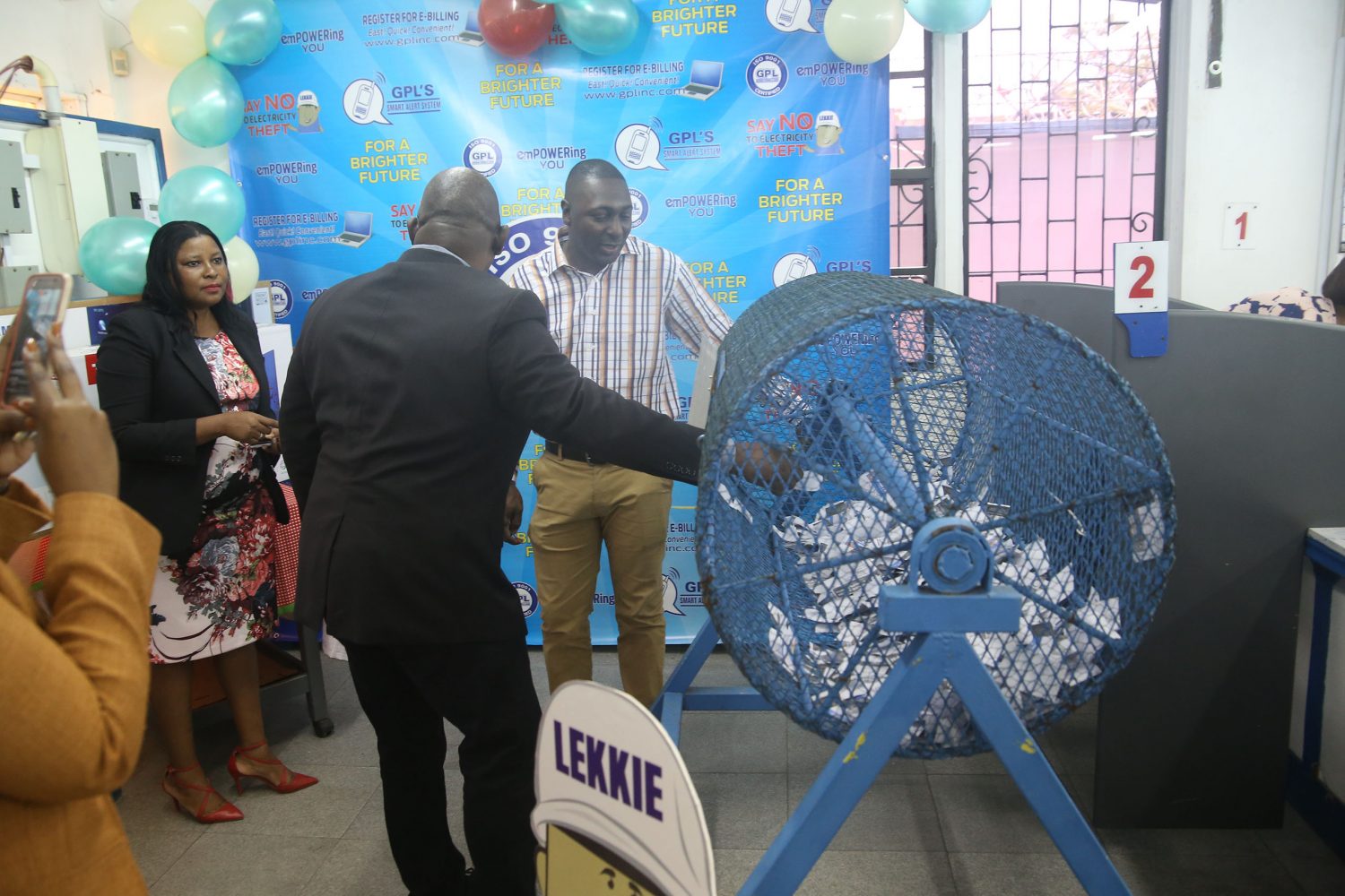 CEO of Guyana Power and Light (GPL) Albert Gordon taking out the coupon for the first prize winner in the Share and Win Promotion on Friday at the Main Street Branch. 