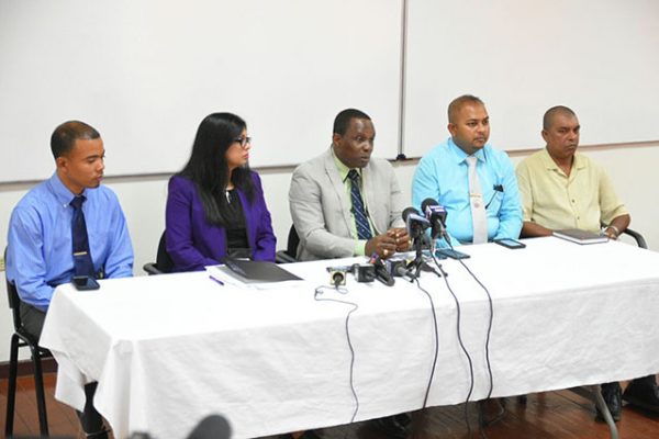 Crime Chief Paul Williams (centre) and women’s rights activist Dianne Madray along with detectives Prem Narine (second from right), Suraj Singh (at right) and Devon Lowe at yesterday’s press conference.