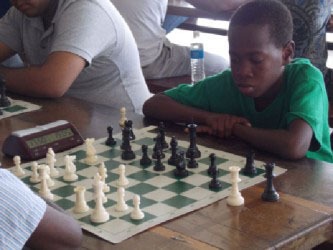 Darwin London (right) at the Banks DIH Malta Chess Tournament held at the University of Guyana Tain Campus in Berbice, in April 2013. I participated in the said tournament and recall London seizing a pawn from me during a minor piece exchange. London is currently in secondary school and he continues winning tournaments.