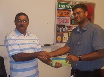 Secretary of LGC Rabindranath ‘Pandit Ravi’ Persaud (left) receives the sponsorship from deputy CEO of Grand Coastal Hotel, Kevin Daby.