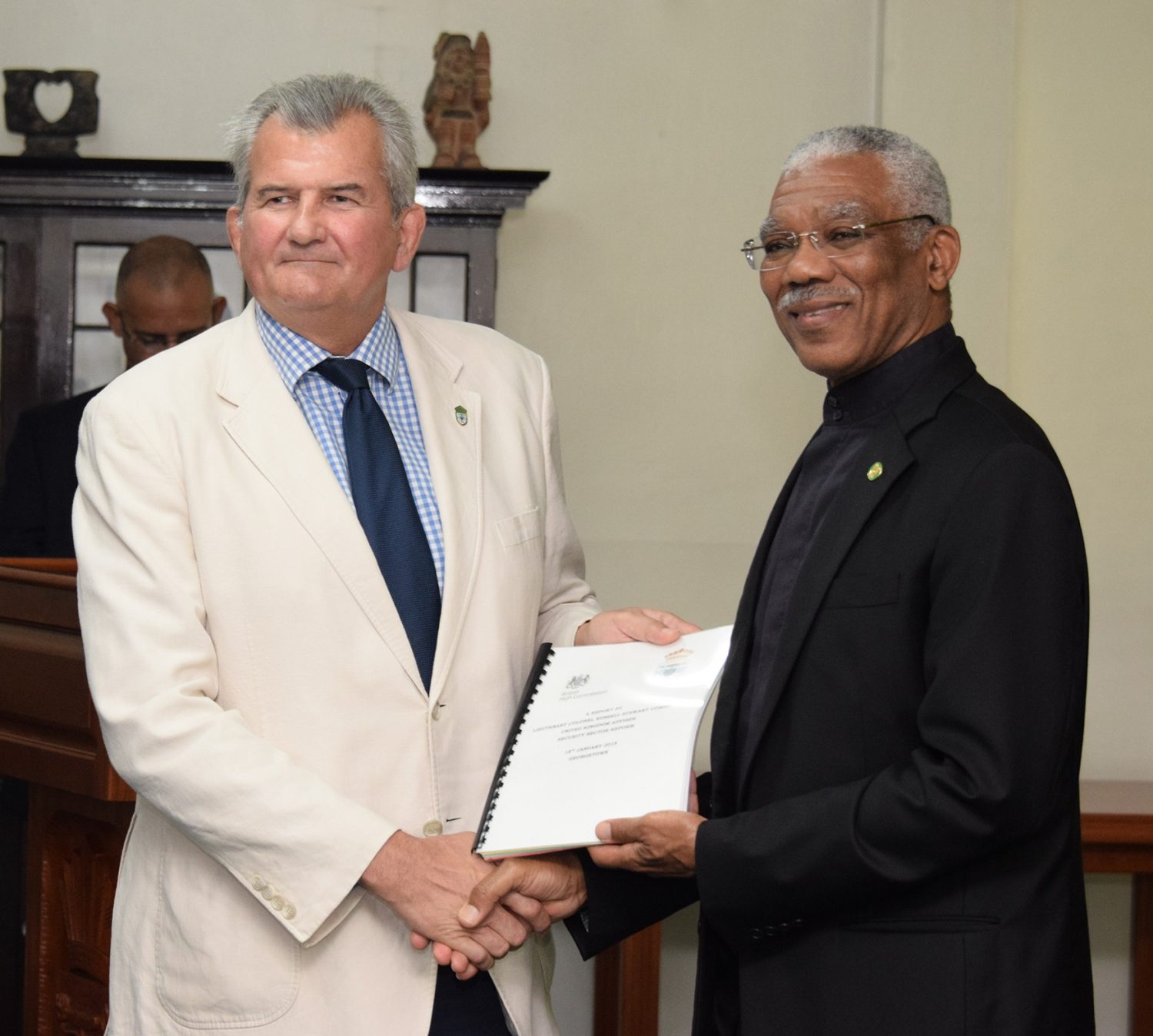 Lt Col (rtd) Russell Combe (at left) handing over the plan to President David Granger in January 