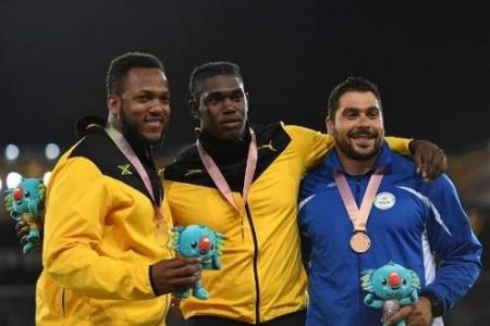 Jamaica’s Fedrick Dacres (C gold), Jamaica’s Traves Smikle (L silver), Cyprus’ Apostolos Parellis (bronze) pose with their medals during the 2018 Gold Coast Commonwealth Games yesterday