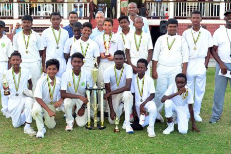 Under – 15 champs pose for a photo along with Coach Gavin Nedd, President of the GCA, Roger Harper and CEO of Toucan distributors Andrew King (Orlando Charles photo) 