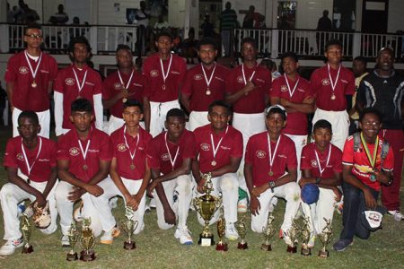 The DCC team poses for a photo opportunity after receiving the championship trophy. Coach Garvin `Tibbsy’ Nedd is at right.