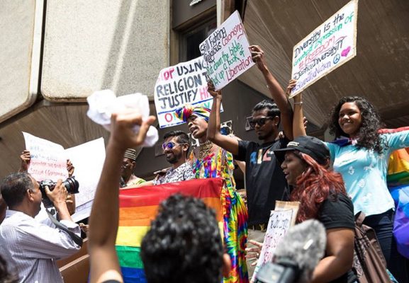 (Courtesy Maria Nunes): Supporters in front the Hall of Justice as they await Justice Rampersad’s ruling