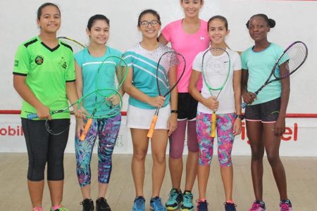 Taylor Fernandes is all smiles with a few of the junior squash girls after a workout at the Georgetown Club squash court yesterday (Royston Alkins photo)
 
