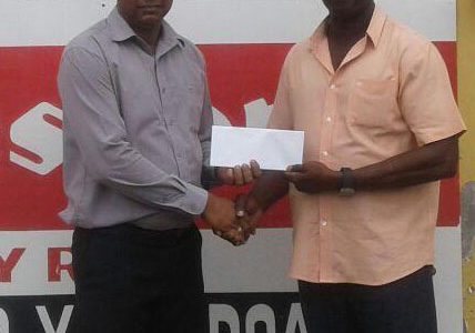 Sales Manager at Ganesh Parts, Suresh Rampersaud (left) hands over the sponsorship to Chairman of the Boyce/Jefford Committee, Colin Boyce yesterday outside the Robb Street Store.