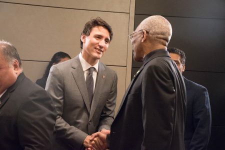 President David Granger (right) greeting Canadian Prime Minister Justin Trudeau yesterday at a meeting of Heads of Small Islands Developing States in London, England where the President is attending the Commonwealth Heads of Government Summit. (Ministry of the Presidency photo) 