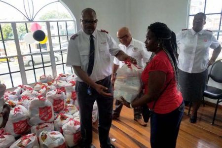 A representative of the Salvation Army distributing the food hampers (DPI photo)