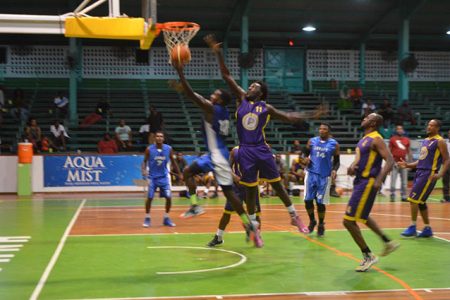 Joslyn Crawford (right) of Pacesetters desperately attempts a block on a Victory Valley Royals player during their group matchup in the 5th edition of the Guyana Amateur Basketball Federation (GABF) ‘Road to Mecca’ Club Championship, at the Cliff Anderson Sports Hall