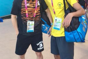 Guyana’s Narayan Ramdhani with the World's top player Lee Chong Wei of Malaysia.
