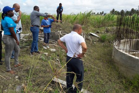 Minister of Public Infrastructure David Patterson (third from left) pointing to the collapsed base. Minister of Natural Resources Raphael Trotman is second from left. Minister of Social Cohesion Dr George Norton is in the foreground.

