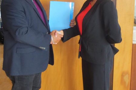 Ramesh Dookhoo (left), Corporate Coordinator of the Private Sector Commission of Guyana and the Chief Executive Officer of the Caribbean Corporate Governance Institute,  Denise Deonarine shake hands after executing the MOU.