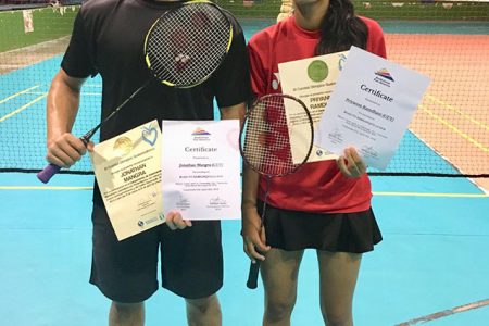Jonathan Mangra (left) and Priyanna Ramdhani showcase their certificates at the end of the training camp.