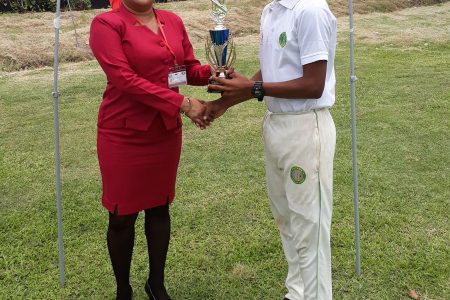 Player of the Match, Sherlan Anthony receives his prize from Vreed-en-Hoop Hand in Hand representative Sarita Mohabir for his match winning 5-36